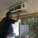 Man Checking at the Split Type Aircon — Air Conditioning in Nightcliff, NT